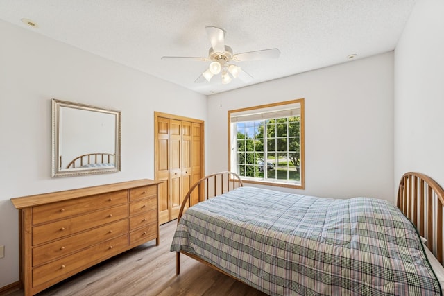 13936 54th Ave N Unit 2, Plymouth, MN 55446 - bedroom featuring light wood finished floors, a closet, a ceiling fan, and a textured ceiling