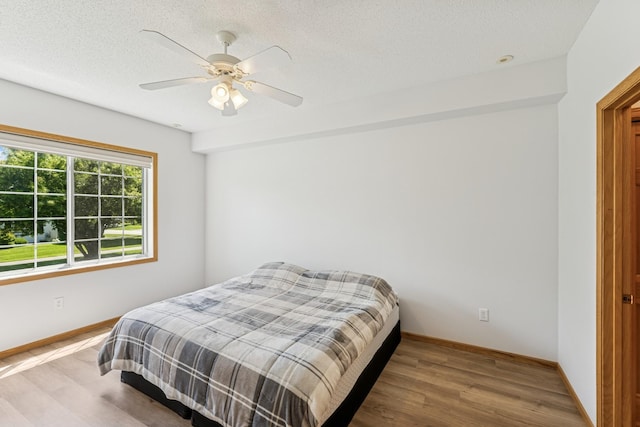 13936 54th Ave N Unit 2, Plymouth, MN 55446 - bedroom featuring wood finished floors, ceiling fan, and a textured ceiling