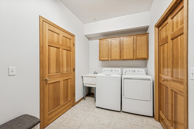 13936 54th Ave N Unit 2, Plymouth, MN 55446 - laundry room featuring cabinet space, washer and clothes dryer, and a textured ceiling