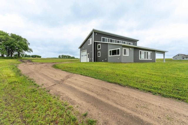 41565 Thunder Rd, Clitherall, MN 56524 - view of front of property featuring driveway, a front lawn, and a garage