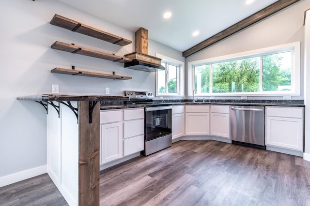 41565 Thunder Rd, Clitherall, MN 56524 - kitchen with appliances with stainless steel finishes, dark wood-style flooring, island range hood, white cabinetry, and recessed lighting