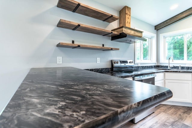 41565 Thunder Rd, Clitherall, MN 56524 - kitchen featuring open shelves, stainless steel electric stove, white cabinets, wood finished floors, and dark stone counters