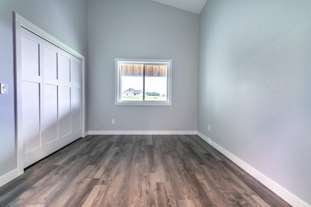 41565 Thunder Rd, Clitherall, MN 56524 - unfurnished bedroom with dark wood-style floors, a closet, and high vaulted ceiling