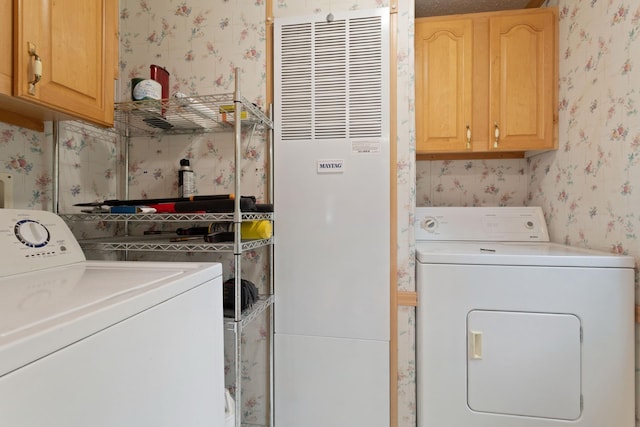 608 Round Lake Ave, Georgetown Twp, WI 54853 - washroom with wallpapered walls, washing machine and clothes dryer, a heating unit, and cabinet space