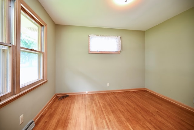 731 Clarks Ln, Winona, MN 55987 - spare room featuring wood finished floors and a baseboard radiator