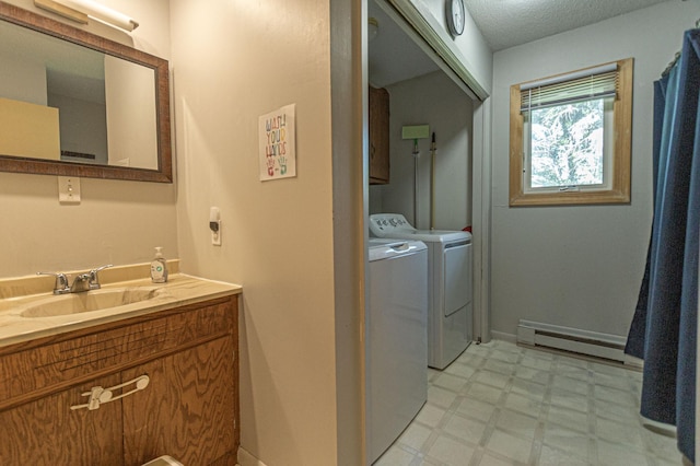 1007 Ruby St NW, Alexandria, MN 56308 - laundry room featuring baseboard heating, light floors, and washer and dryer