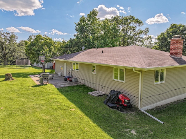 1007 Ruby St NW, Alexandria, MN 56308 - rear view of property with a patio area, a yard, a chimney, and a shingled roof
