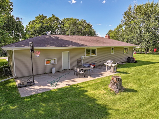 1007 Ruby St NW, Alexandria, MN 56308 - back of property featuring a lawn, a chimney, a patio area, and a shingled roof