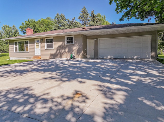 1007 Ruby St NW, Alexandria, MN 56308 - ranch-style house featuring driveway, an attached garage, a chimney, and entry steps