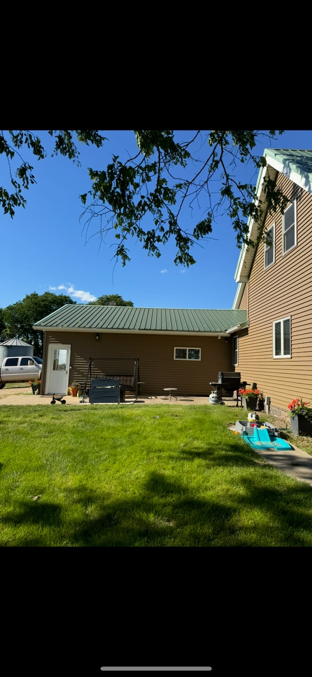 74194 415th St, South Branch Twp, MN 56081 - back of property with a yard and a metal roof