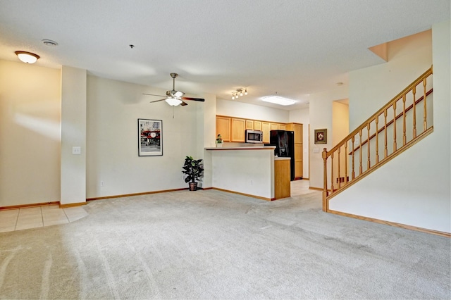 11307 Chisholm Cir NE Unit C, Blaine, MN 55449 - unfurnished living room featuring light carpet, a ceiling fan, and stairs