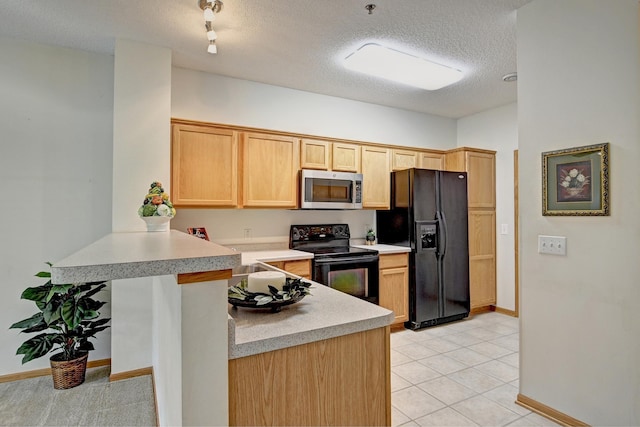 11307 Chisholm Cir NE Unit C, Blaine, MN 55449 - kitchen with black appliances, a peninsula, light countertops, light brown cabinets, and a textured ceiling