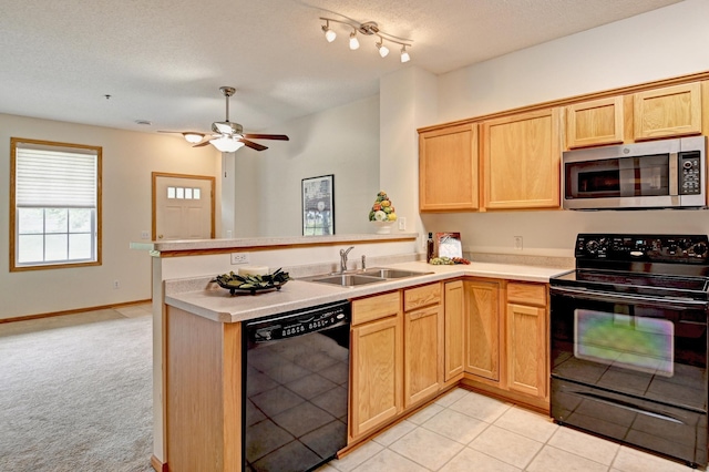 11307 Chisholm Cir NE Unit C, Blaine, MN 55449 - kitchen with black appliances, a peninsula, light countertops, a ceiling fan, and a textured ceiling