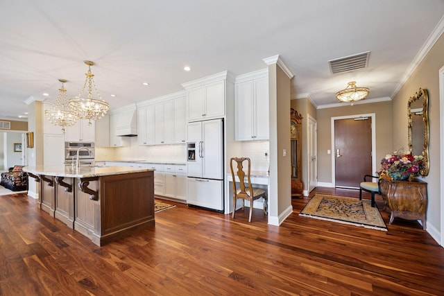 875 Lake St N Unit 318, Wayzata, MN 55391 - kitchen featuring paneled built in fridge, tasteful backsplash, dark wood-style flooring, white cabinetry, and ornamental molding