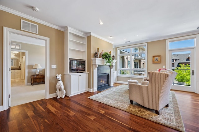 875 Lake St N Unit 318, Wayzata, MN 55391 - living room with crown molding, dark wood-type flooring, a fireplace with flush hearth, built in features, and recessed lighting