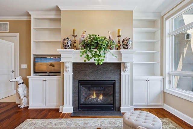 875 Lake St N Unit 318, Wayzata, MN 55391 - living area featuring wood finished floors, a high end fireplace, built in features, and crown molding