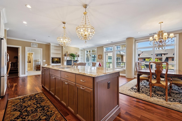 875 Lake St N Unit 318, Wayzata, MN 55391 - kitchen featuring a chandelier, dark wood-style floors, open floor plan, ornamental molding, and light stone counters