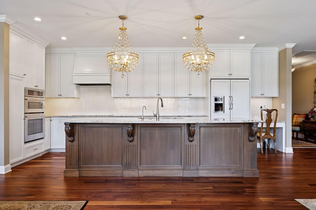 875 Lake St N Unit 318, Wayzata, MN 55391 - kitchen featuring paneled built in refrigerator, a chandelier, premium range hood, dark wood-type flooring, and recessed lighting