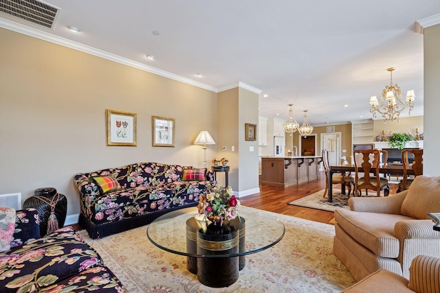 875 Lake St N Unit 318, Wayzata, MN 55391 - living area featuring a chandelier, ornamental molding, wood finished floors, and recessed lighting