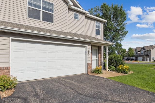 12651 8th Ave S, Zimmerman, MN 55398 - view of front of home featuring brick siding, driveway, a front lawn, a garage, and roof with shingles