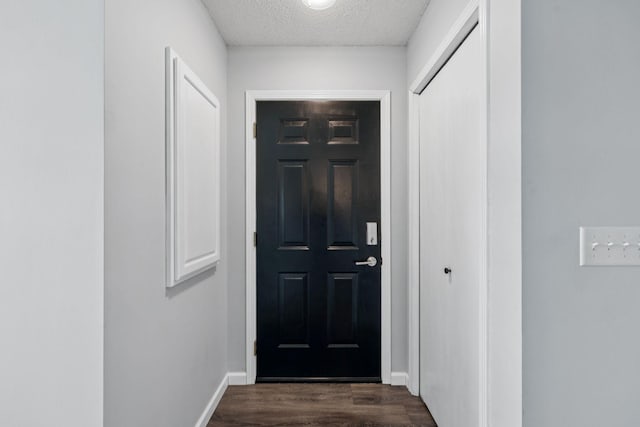12651 8th Ave S, Zimmerman, MN 55398 - doorway featuring dark wood-style floors and a textured ceiling