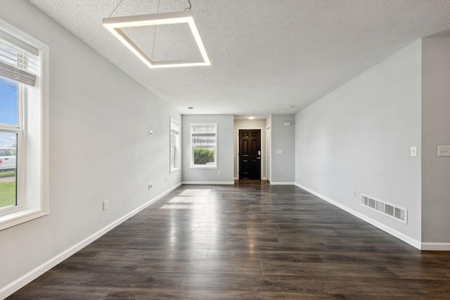 12651 8th Ave S, Zimmerman, MN 55398 - spare room with a textured ceiling and dark wood-style floors