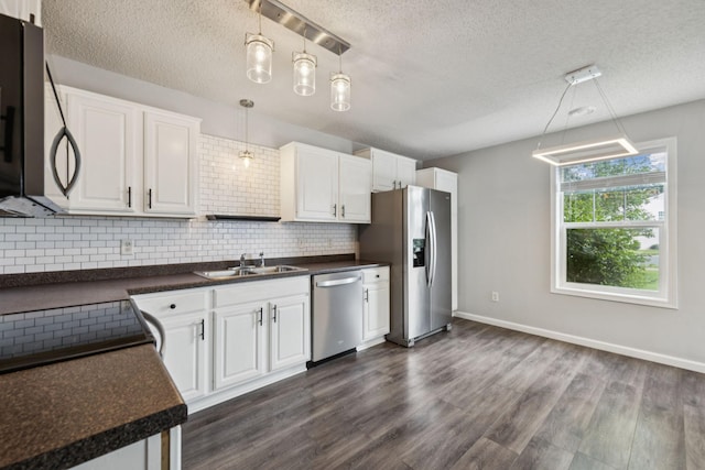 12651 8th Ave S, Zimmerman, MN 55398 - kitchen with stainless steel appliances, a textured ceiling, dark countertops, tasteful backsplash, and dark wood-style floors