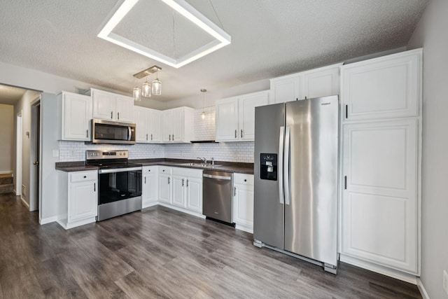 12651 8th Ave S, Zimmerman, MN 55398 - kitchen with appliances with stainless steel finishes, dark countertops, white cabinetry, backsplash, and a textured ceiling