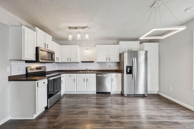 12651 8th Ave S, Zimmerman, MN 55398 - kitchen featuring appliances with stainless steel finishes, dark countertops, a textured ceiling, and tasteful backsplash