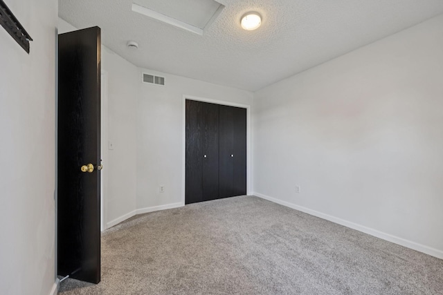 12651 8th Ave S, Zimmerman, MN 55398 - unfurnished bedroom with carpet flooring, a textured ceiling, attic access, and a closet