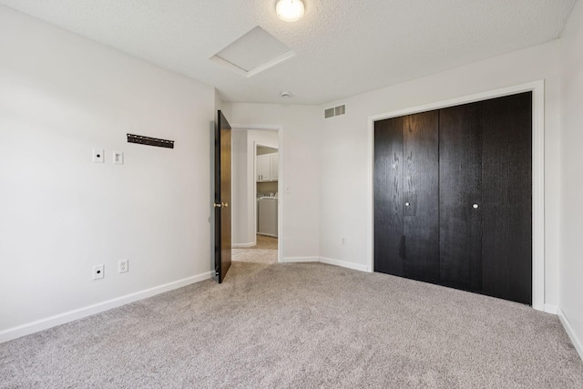 12651 8th Ave S, Zimmerman, MN 55398 - unfurnished bedroom with attic access, carpet floors, a closet, and a textured ceiling