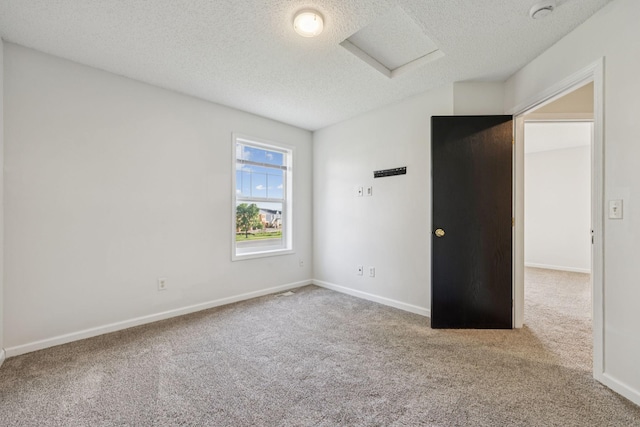 12651 8th Ave S, Zimmerman, MN 55398 - unfurnished bedroom featuring carpet floors, a textured ceiling, and attic access