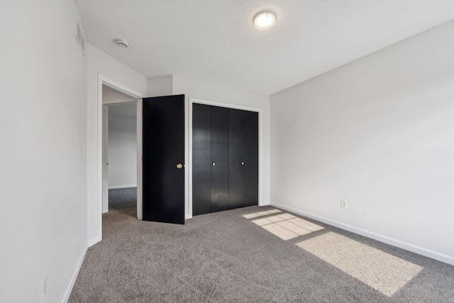 12651 8th Ave S, Zimmerman, MN 55398 - unfurnished bedroom featuring carpet flooring, a closet, and a textured ceiling