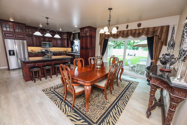 915 Darling Dr NW, Alexandria, MN 56308 - dining space featuring a chandelier, light wood-type flooring, and recessed lighting
