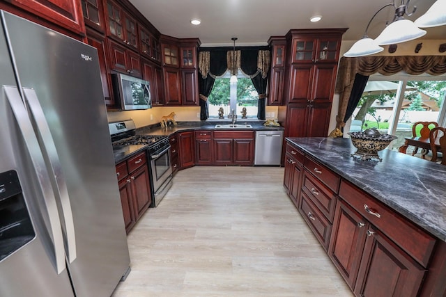 915 Darling Dr NW, Alexandria, MN 56308 - kitchen with appliances with stainless steel finishes, dark brown cabinets, light wood finished floors, and recessed lighting