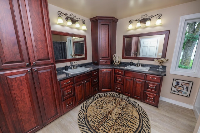 915 Darling Dr NW, Alexandria, MN 56308 - full bath featuring double vanity and wood finished floors
