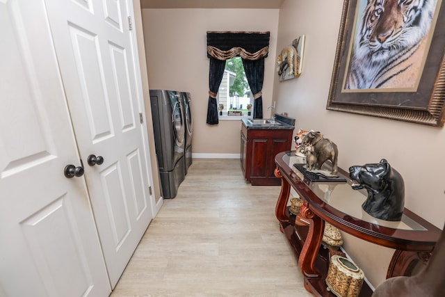 915 Darling Dr NW, Alexandria, MN 56308 - corridor featuring washer and clothes dryer and light wood-style floors