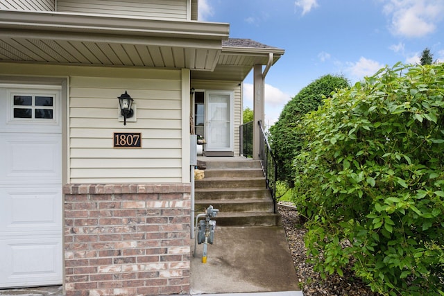 1807 Lachman Ave NE, Saint Michael, MN 55376 - view of exterior entry with covered porch, a garage, and a shingled roof