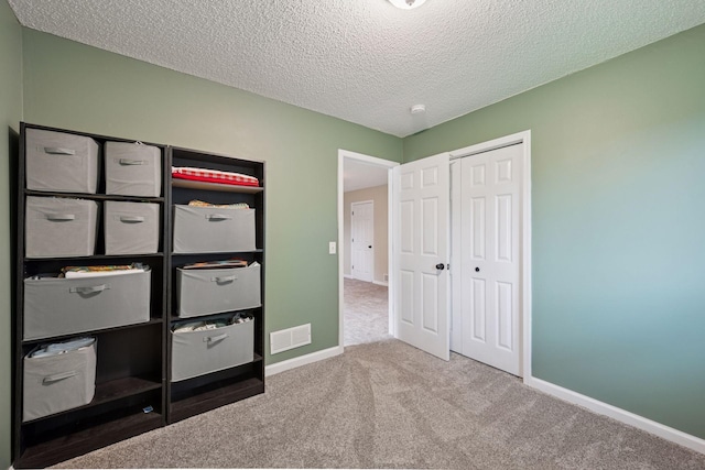 1807 Lachman Ave NE, Saint Michael, MN 55376 - unfurnished bedroom featuring carpet, a textured ceiling, and a closet