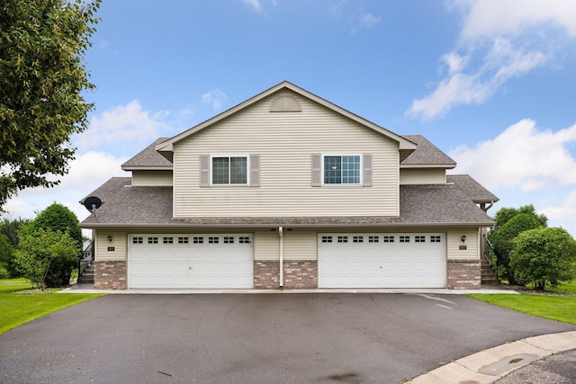 1807 Lachman Ave NE, Saint Michael, MN 55376 - traditional home featuring brick siding, an attached garage, and roof with shingles