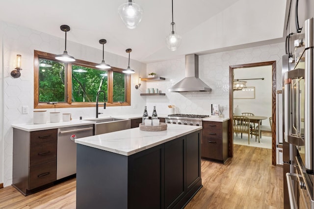 6205 Saint Albans Cir, Edina, MN 55439 - kitchen featuring wall chimney exhaust hood, stainless steel appliances, light wood-style floors, backsplash, and decorative light fixtures