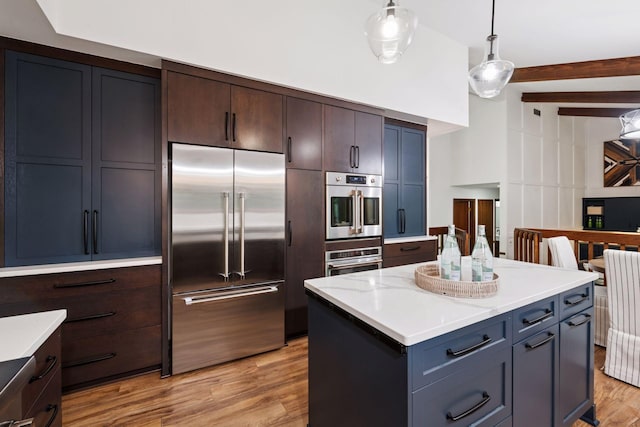 6205 Saint Albans Cir, Edina, MN 55439 - kitchen with appliances with stainless steel finishes, light wood-style flooring, pendant lighting, beam ceiling, and a center island
