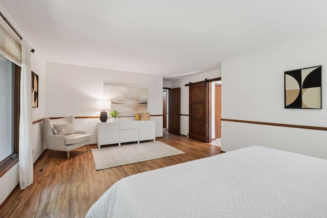 6205 Saint Albans Cir, Edina, MN 55439 - bedroom with a barn door and wood finished floors