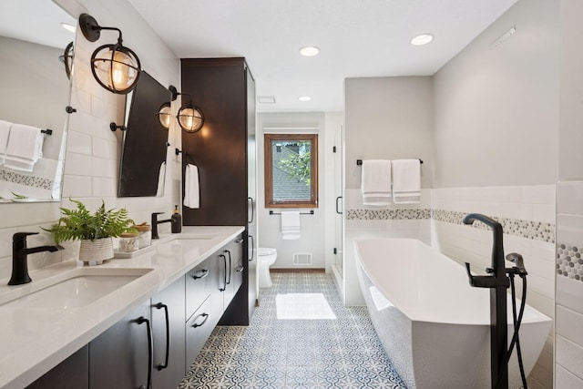 6205 Saint Albans Cir, Edina, MN 55439 - full bathroom featuring a freestanding bath, double vanity, recessed lighting, tile patterned floors, and a shower stall
