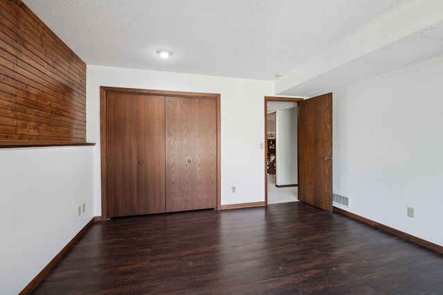 6205 Saint Albans Cir, Edina, MN 55439 - unfurnished bedroom with wood finished floors, a closet, and a textured ceiling