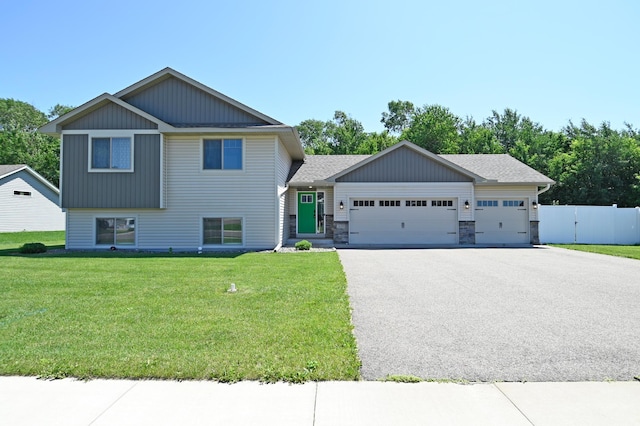 38391 Hunters Ridge Trl, North Branch, MN 55056 - tri-level home with a garage, driveway, and stone siding
