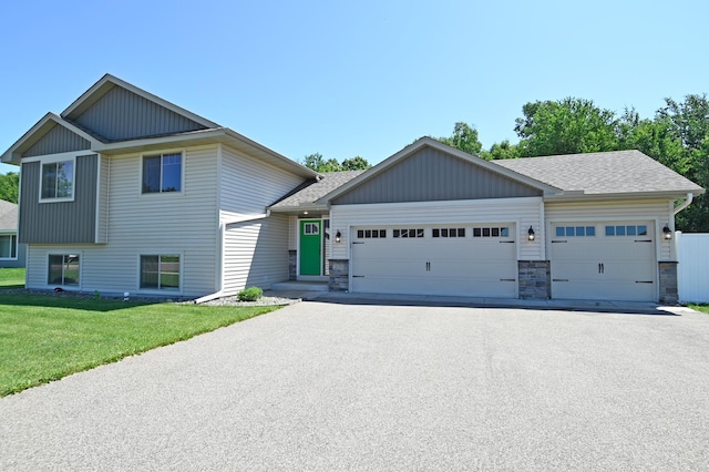 38391 Hunters Ridge Trl, North Branch, MN 55056 - view of front facade featuring an attached garage, driveway, a front yard, and roof with shingles