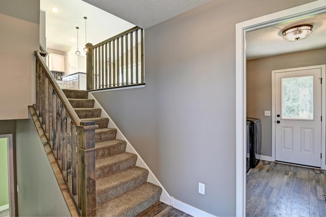 38391 Hunters Ridge Trl, North Branch, MN 55056 - stairway featuring washing machine and clothes dryer and wood finished floors