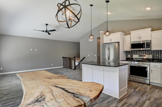 38391 Hunters Ridge Trl, North Branch, MN 55056 - kitchen featuring stainless steel appliances, vaulted ceiling, a kitchen island, white cabinetry, and decorative backsplash