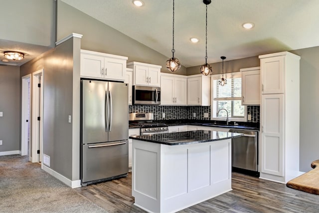 38391 Hunters Ridge Trl, North Branch, MN 55056 - kitchen with stainless steel appliances, vaulted ceiling, backsplash, white cabinetry, and a kitchen island
